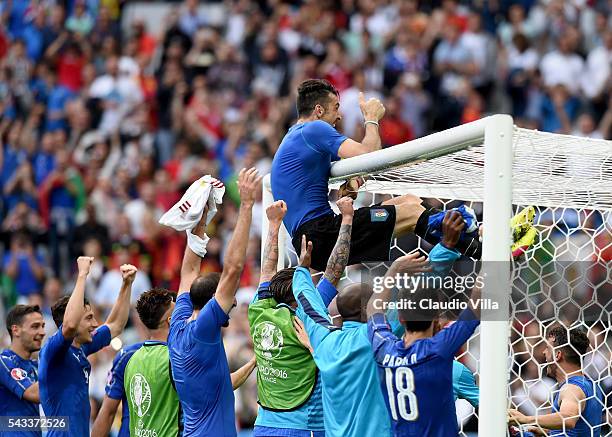 Gianluigi Buffon of Italy clings on the crossbar to celebrates his team's 2-0 win in the UEFA EURO 2016 round of 16 match between Italy and Spain at...