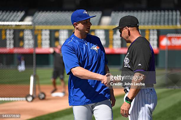 Colorado Rockies manager Walt Weiss shakes hands with Toronto Blue Jays shortstop Troy Tulowitzki during batting practice June 27, 2016 at Coors...