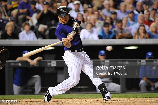 Brandon Barnes of the Colorado Rockies hits a double in the seventh inning against the Toronto Blue Jays at Coors Field on June 27, 2016 in Denver,...