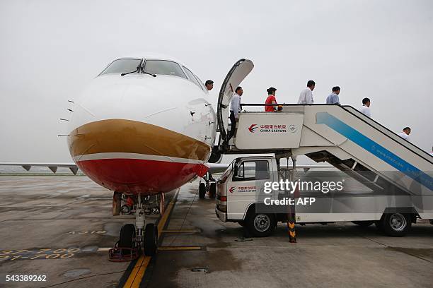 An ARJ21-700, China's first domestically produced regional jet, arrives at Shanghai Hongqiao Airport after making its first flight from Chengdu to...