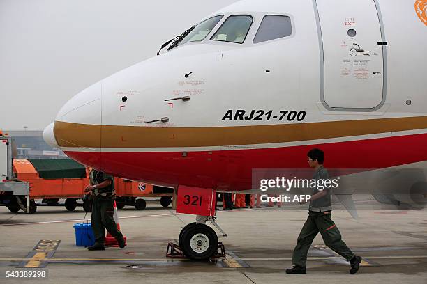 An ARJ21-700, China's first domestically produced regional jet, arrives at Shanghai Hongqiao Airport after making its first flight from Chengdu to...
