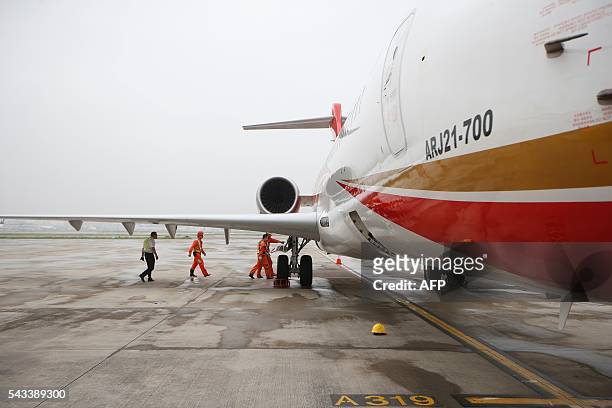 An ARJ21-700, China's first domestically produced regional jet, arrives at Shanghai Hongqiao Airport after making its first flight from Chengdu to...