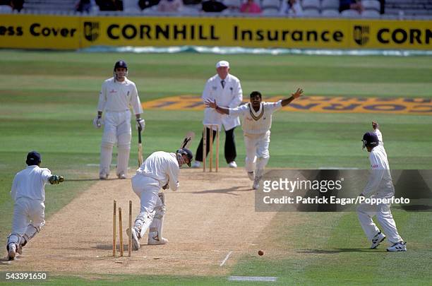 John Crawley of England is bowled by Muttiah Muralitharan of Sri Lanka for 14 runs in the second innings of the only Test match between England and...