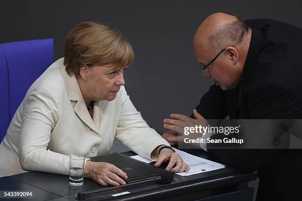 German Chancellor Angela Merkel speaks with Minister of the Chancellery Peter Altmeier after she addressed the Bundestag with a government...