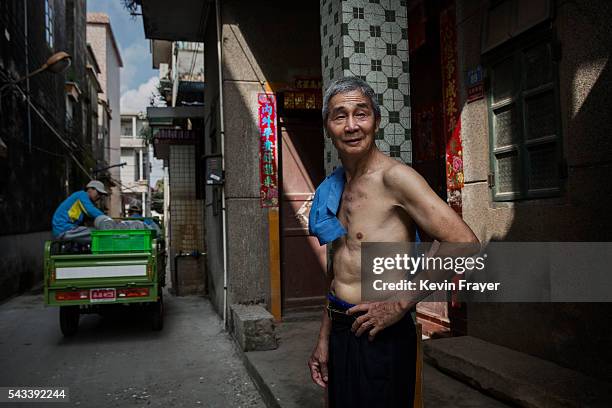 A Chinese man stands in an alleyway of a village on Shazai Island where the Sun Yat-Sen University-Michigan University Joint Center of Vector Control...