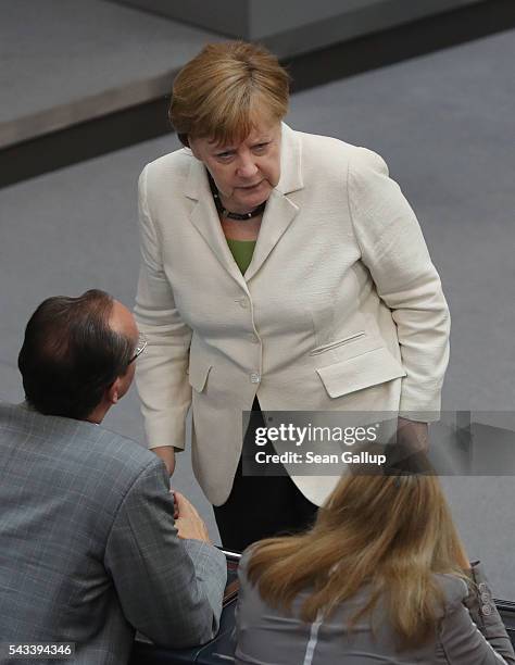 German Chancellor Angela Merkel chats with paliamentarians after she addressed the Bundestag with a government declaration on the recent Brexit vote...