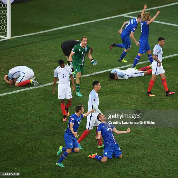 Gylfi Sigurdsson of Iceland falls to his knees in celebration as his team knock out England in the UEFA Euro 2016 Round of 16 match between England...