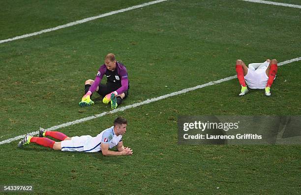 Gary Cahill,Joe Hart and Dele Alli of England show their dissapointment after defeat during the UEFA Euro 2016 Round of 16 match between England and...