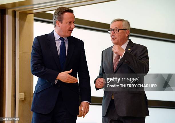 British Prime Minister David Cameron speaks with European Union Commission President Jean-Claude Juncker prior to a meeting at the European Union...