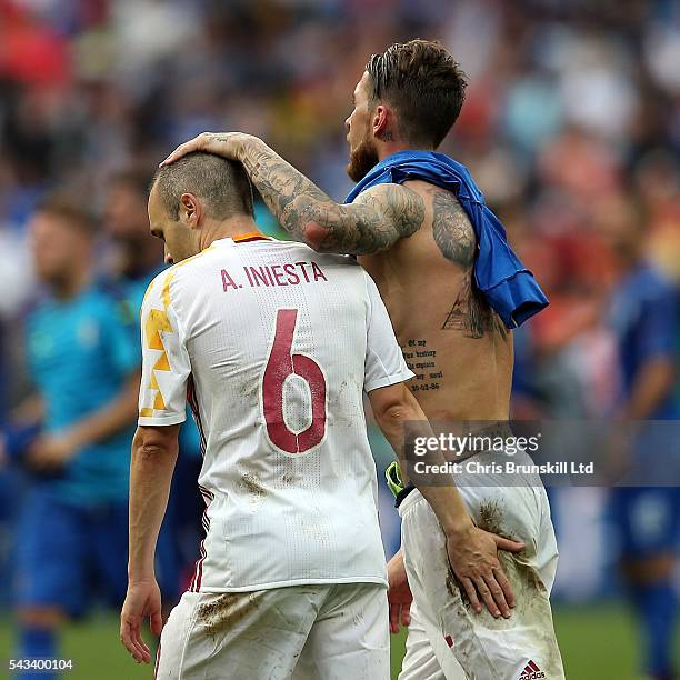 Sergio Ramos of Spain consoles team-mate Andres Iniesta at full-time following the UEFA Euro 2016 Round of 16 match between Italy and Spain at Stade...