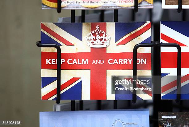 Postcard reading "Keep Calm and Carry On" sits in a rack outside a newsagent in London, U.K., on Tuesday, June 28, 2016. The pound rose for the first...