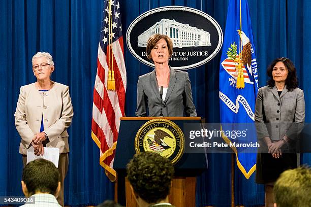 Flanked by Environmental Protection Agency Administrator Gina McCarthy and Federal Trade Commission Chairwoman Edith Ramirez , Deputy Attorney...