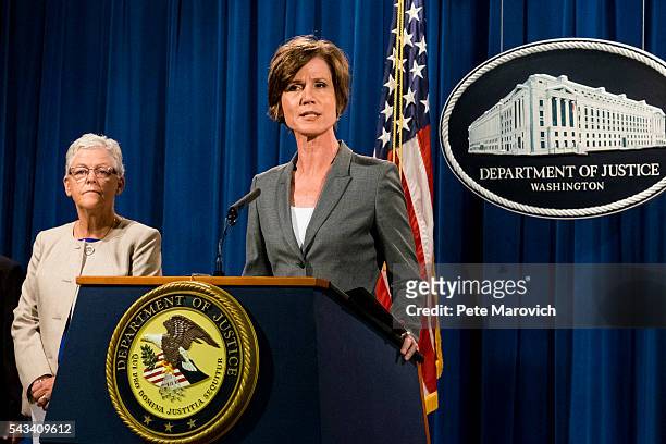 Environmental Protection Agency Administrator Gina McCarthy looks on as Deputy Attorney General Sally Q. Yates speaks during a press conference at...