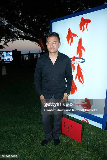 Artist Liu Bolin poses in front of his work during Fred Jeweler Celebrates 80 Years of Creation at Hotel Cap Estel in Eze, France on June 23, 2016.