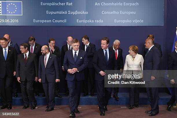 British Prime Minister David Cameron leaves after the group family photo with the European Council during a European Council Meeting at the Council...