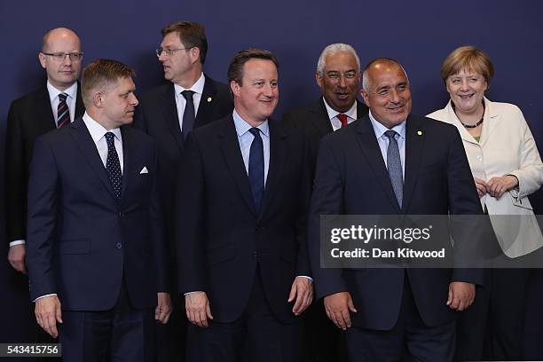 British Prime Minister David Cameron waits for the group family photo with the European Council including German Chancellor Angela Merkel during a...