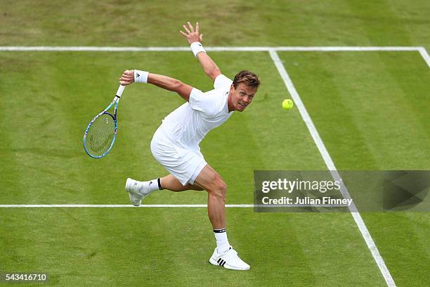 Tomas Berdych of The Czech republic plays a backhand during the Men's Singles first round match against Ivan Dodig of Croatia on day two of the...