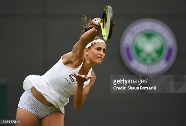 Monica Puig of Puerto Rico serves during the Ladies Singles first round match gainst Johanna Konta of Great Britain on day two of the Wimbledon Lawn...