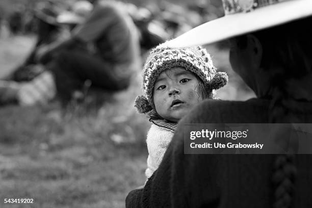 Tawarchapi, Bolivia Little girl in her mother's arms in the Andes of Bolivia on April 15, 2016 in Tawarchapi, Bolivia.