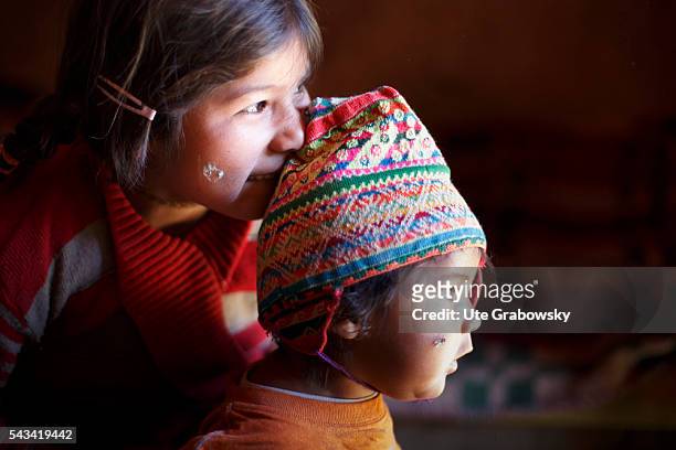 Tarwachapi, Bolivia Portrait of a girl and her brother in the Andes of Bolivia on April 16, 2016 in Tarwachapi, Bolivia.