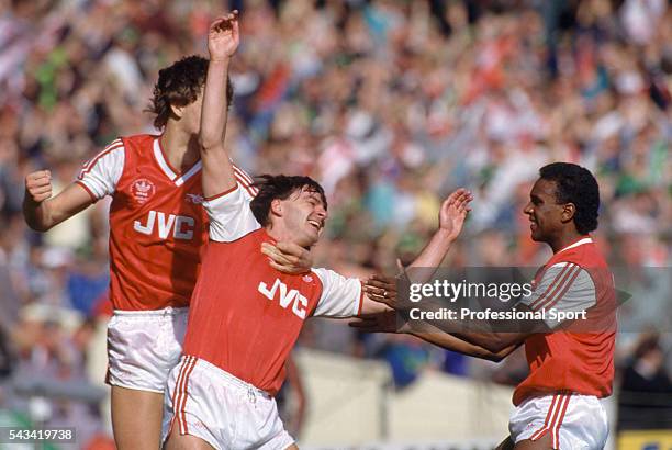 Charlie Nicholas of Arsenal celebrates with Tony Adams and David Rocastle after scoring the 1st goal during the Littlewoods League Cup Final between...