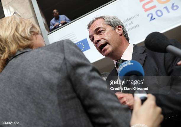 Independence Party leader Nigel Farage speaks to the media as he attends a European Council Meeting at the Council of the European Union on June 28,...