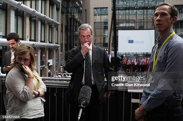 Independence Party leader Nigel Farage prepares for the media as he attends a European Council Meeting at the Council of the European Union on June...