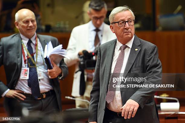 European Commission President Jean Claude Juncker looks on as he walks during EU - Summit at the EU headquarters in Brussels on June 28, 2016. Prime...