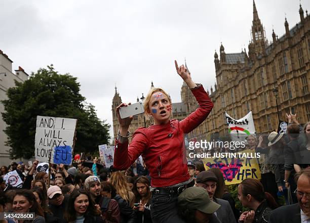 Demonstrators march onto College Green outside The Houses of Parliament at an anti-Brexit protest in central London on June 28, 2016. EU leaders...