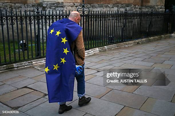 Demonstrator wrapped in a European flag leaves an anti-Brexit protest in central London on June 28, 2016. EU leaders attempted to rescue the European...