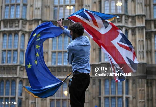 Man waves both a Union flag and a European flag together on College Green outside The Houses of Parliament at an anti-Brexit protest in central...