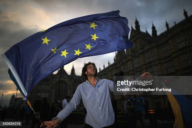 Protester waves an EU flag in front of the Houses of Parliament as they demonstrate against the EU referendum result on June 28, 2016 in London,...