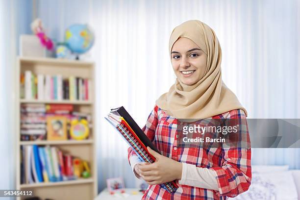 teenage muslim student girl standing at home - girl scarf stock pictures, royalty-free photos & images