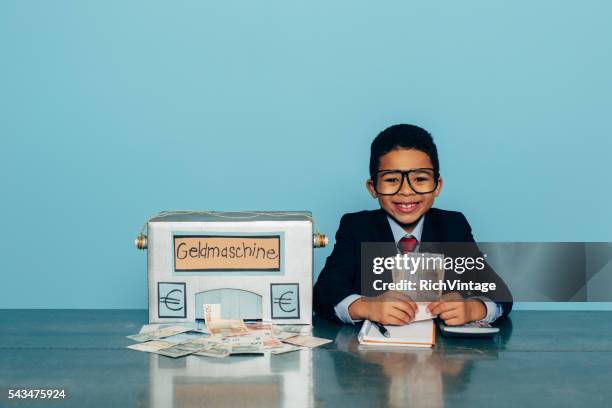 german business boy makes euros with money machine - adult imitation stock pictures, royalty-free photos & images