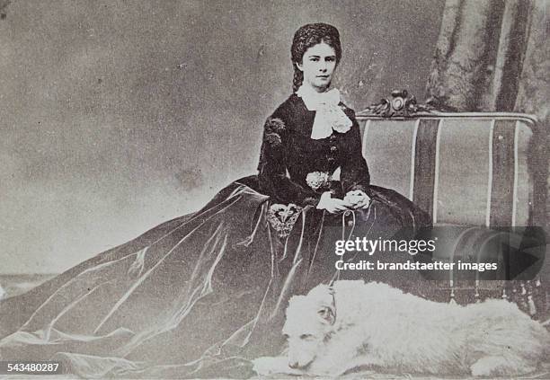 Empress Elisabeth in velvet dress with her dog Houseguard. 1865/66. Photograph by Emil Rabending.