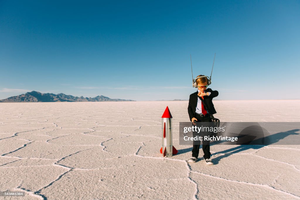 Young Boy Businessman Launching Rocket