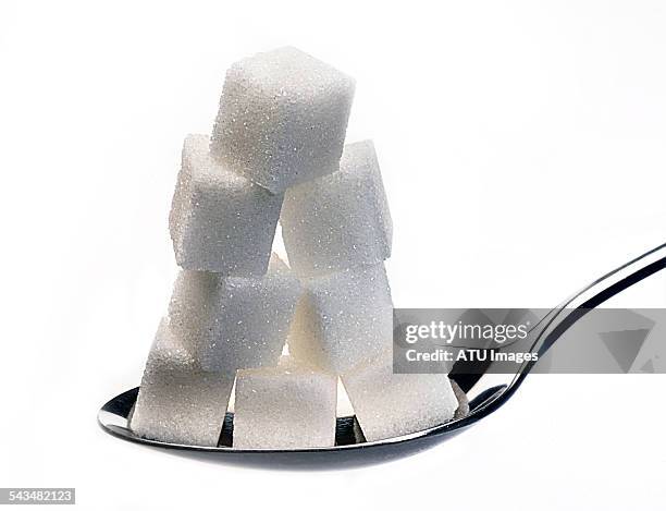 sugar on silver spoon - sugar stockfoto's en -beelden