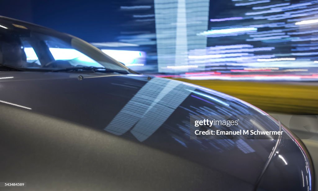 On board a driving car - hood in foreground