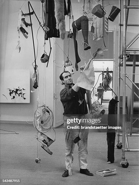 Swiss artist Jean Tinguely with huis sculpture Ballet des pauvres at the Modern Museum . Stockholm. Sweden. 16th May 1961. Photograph