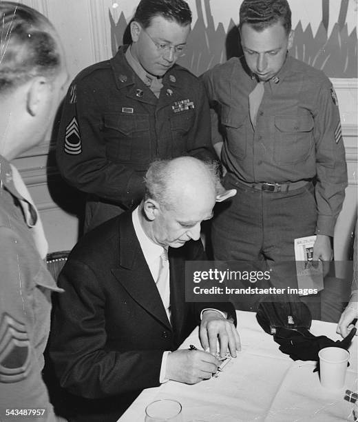 The art director of the Salzburg Festival Wilhelm Furtwaengler is signing autographs for allied soldiers. Salzburg. About 1948. Photograph.