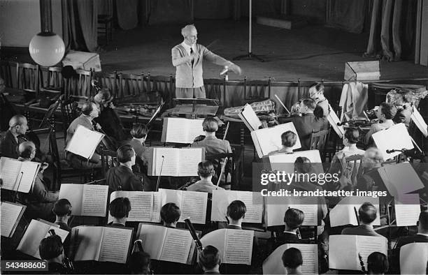 Wilhelm Furtwaengler is conducting the Berlin Philhamonic during a rehearsal. Titania Palast Berlin. 24 May 1947. Photograph.