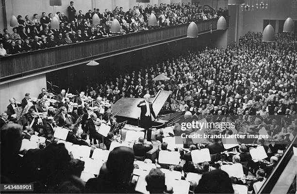 Wilhelm Furtwaengler is conducting the fifth Symphonic concert at Lucerne Festival. In the foreground the pianist Edwin Fischer. About 1955....