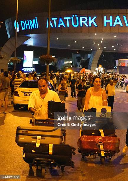 Passengers leave Turkey's largest airport, Istanbul Ataturk, after the suicide bomb attacks, June 28, 2016 in Istanbul, Turkey. Three suicide bombers...