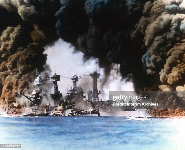 Thick smoke billows up from stricken American warships along battleship row during the Japanese attack on Pearl Harbor, Honolulu, Oahu, Hawaii,...