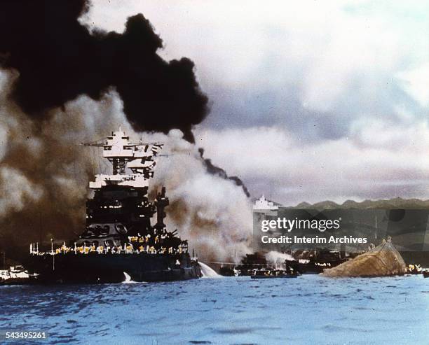 The battleship USS Maryland survived while the USS Oklahoma , to which it was connected by a gangway, rolled over and capsized during the attack on...