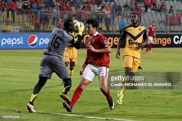 Egypt's Al-Ahly player Amr Gamal vies with Ivory Coast's Asec Mimosas Gol keaper Yao Kouassi during their CAF Champions League group B stage football...