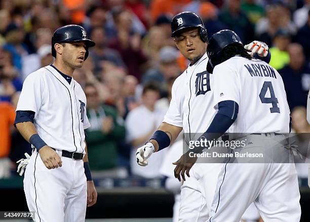 Miguel Cabrera of the Detroit Tigers celebrates his three-run home run against the Miami Marlins with Cameron Maybin of the Detroit Tigers and Ian...