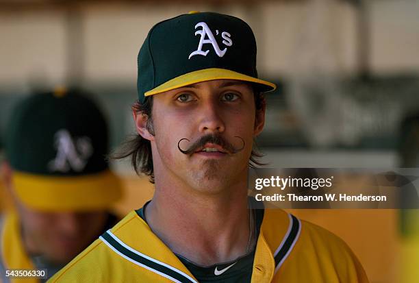 Daniel Mengden of the Oakland Athletics looks on from the dugout after he was taken out of the game against the Texas Rangers in the top of the...