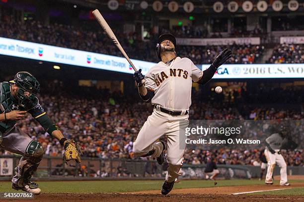 Gregor Blanco of the San Francisco Giants reacts after getting hit by a pitch from Marc Rzepczynski of the Oakland Athletics during the sixth inning...