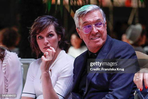 Milla Jovovich and Helmut Schlotterer attend the Marc Cain show spring/summer 2017 at CITY CUBE Panorama Bar on June 28, 2016 in Berlin, Germany.